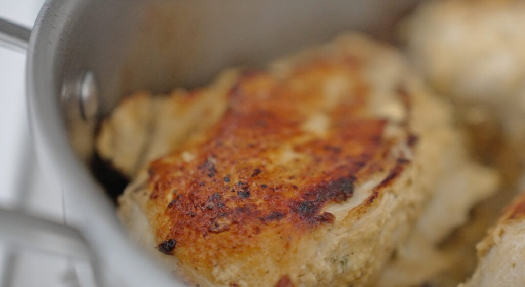 A piece of chicken that has been seared on one side