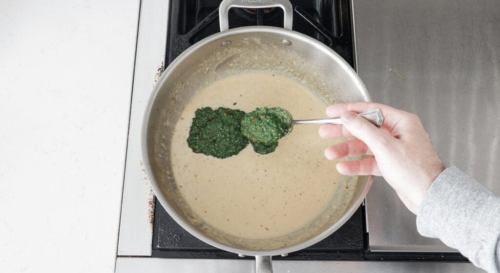 Adding a spoonful of pests to the pan