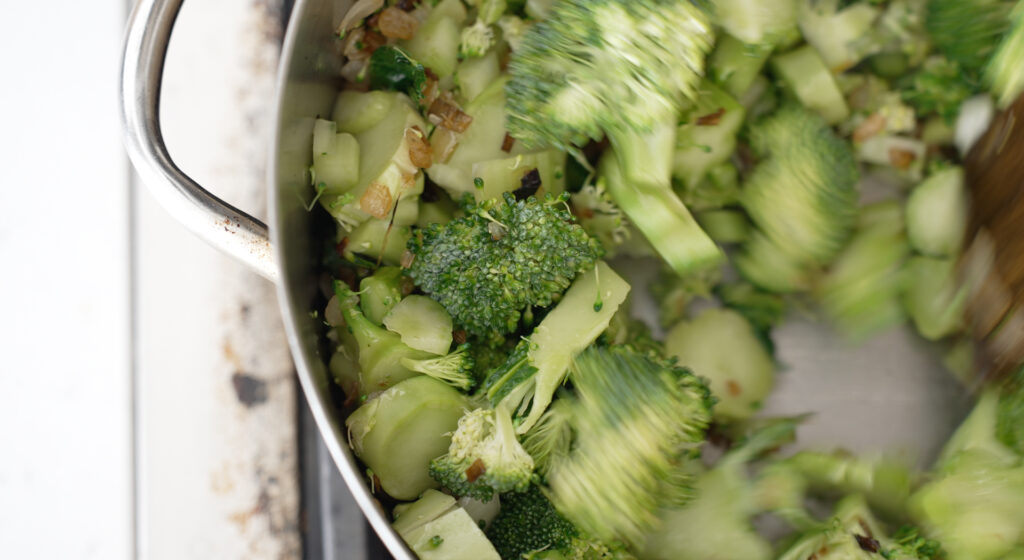 bright green broccoli added to the pot