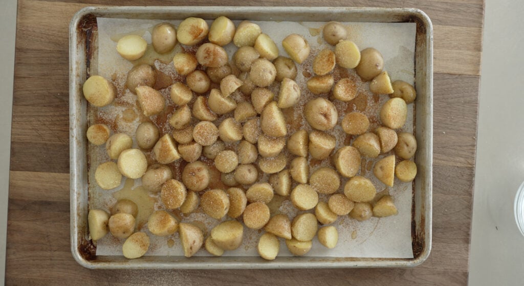 potato halves on a sheet tray lined with parchment paper