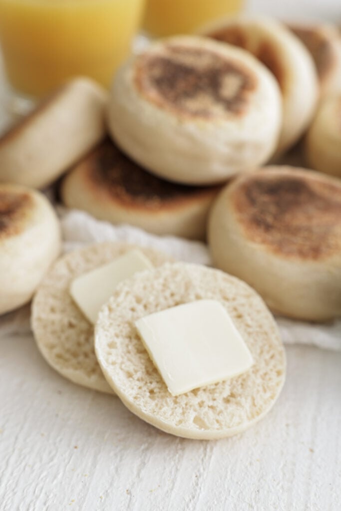 English muffin sliced in half with butter 