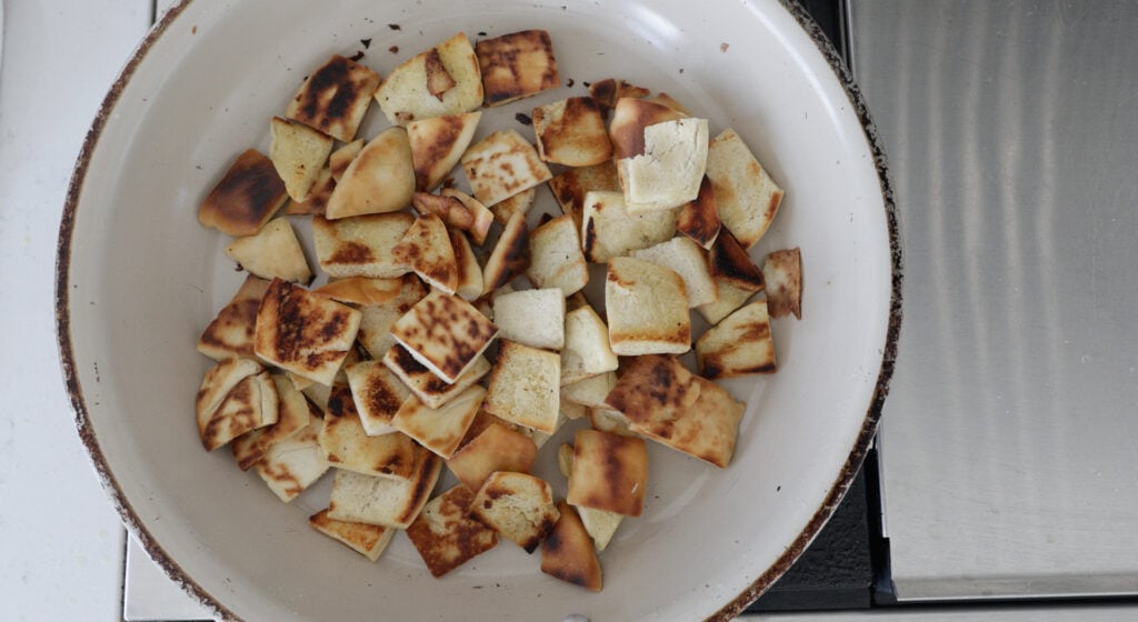 Browned Pita pieces in a skillet