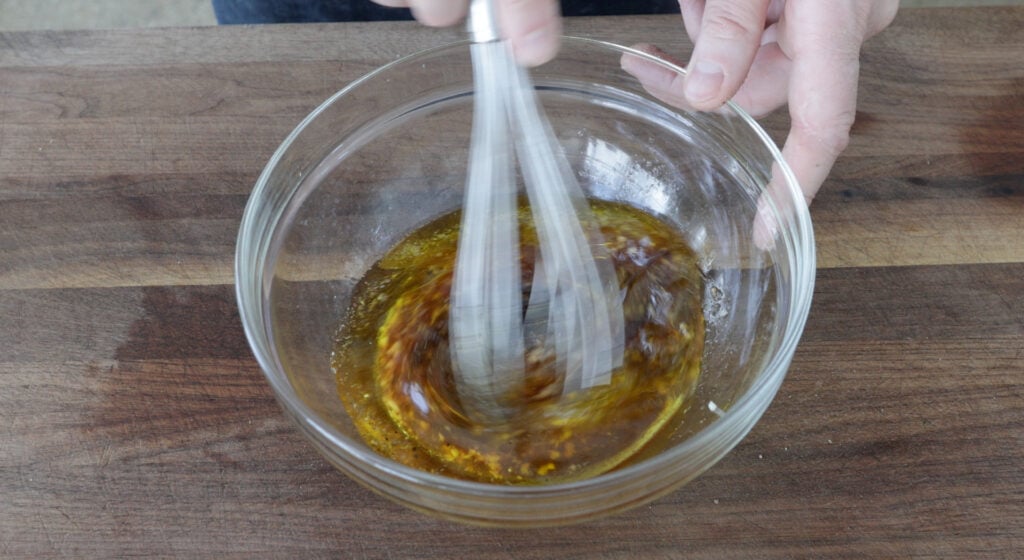 whisking the ingredients for the dressing