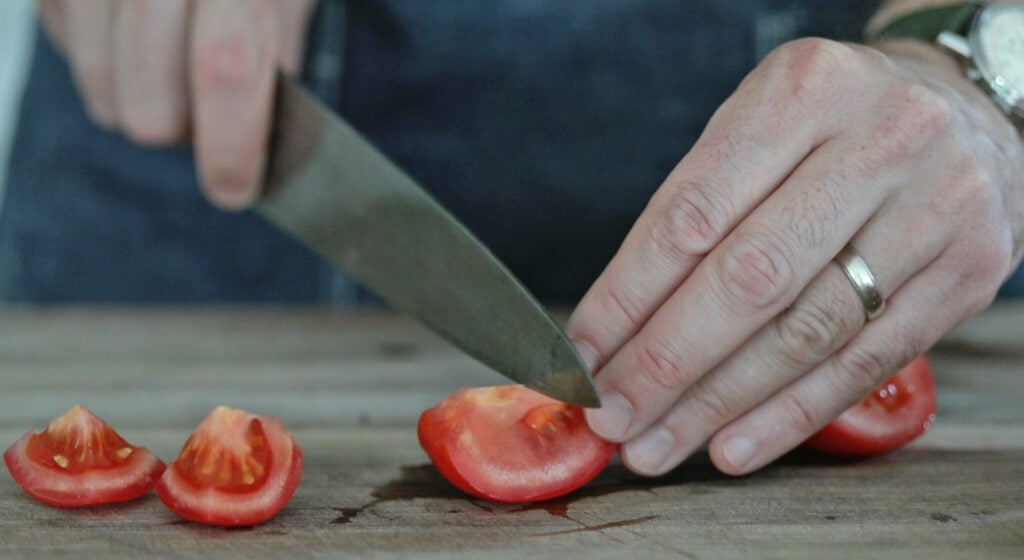 slicing a vine ripe tomato