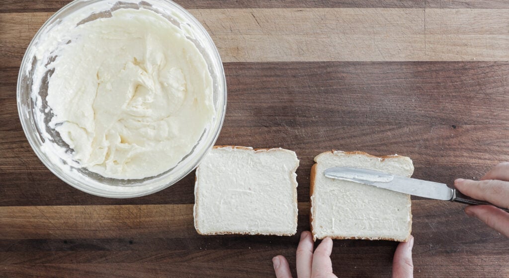 speading butter mixture on 2 pieces of bread