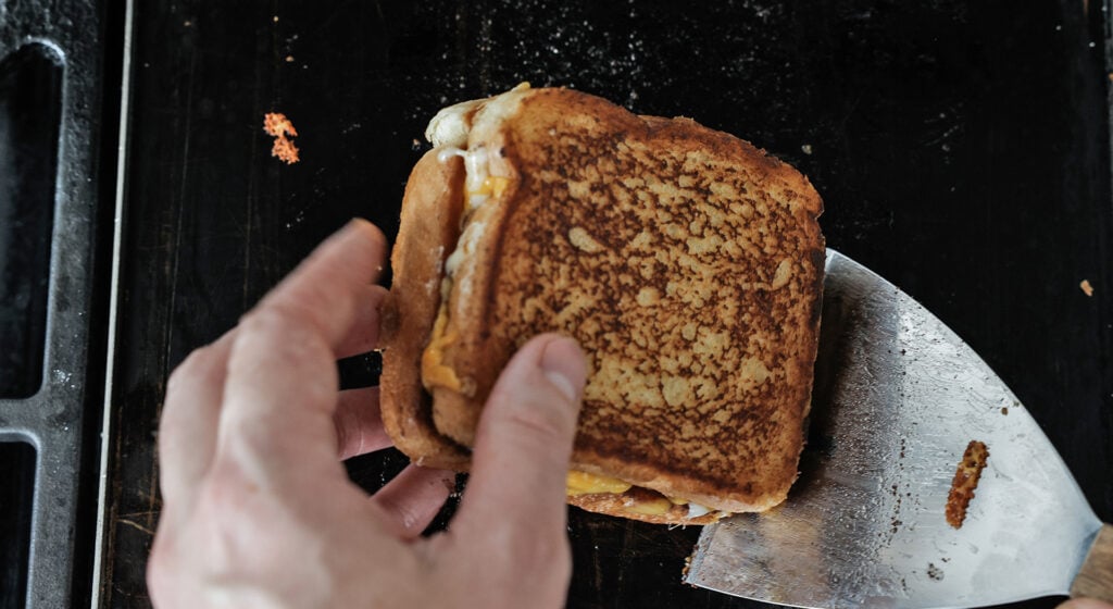 flipping a grilled cheese sandwich