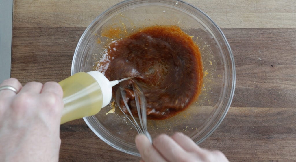 combining marinade ingredients with a whisk