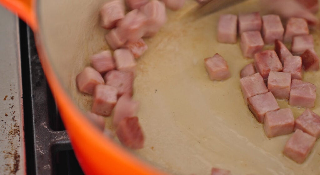 slighty browned Diced ham in the bottom of a pot
