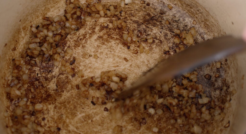 Brown onions in the bottom of a pot