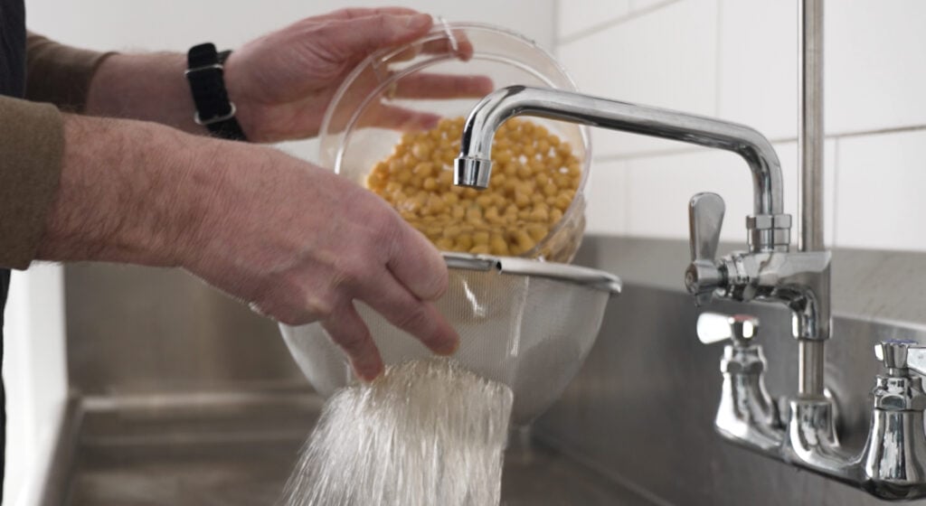 Using a colander to Drain chickpeas