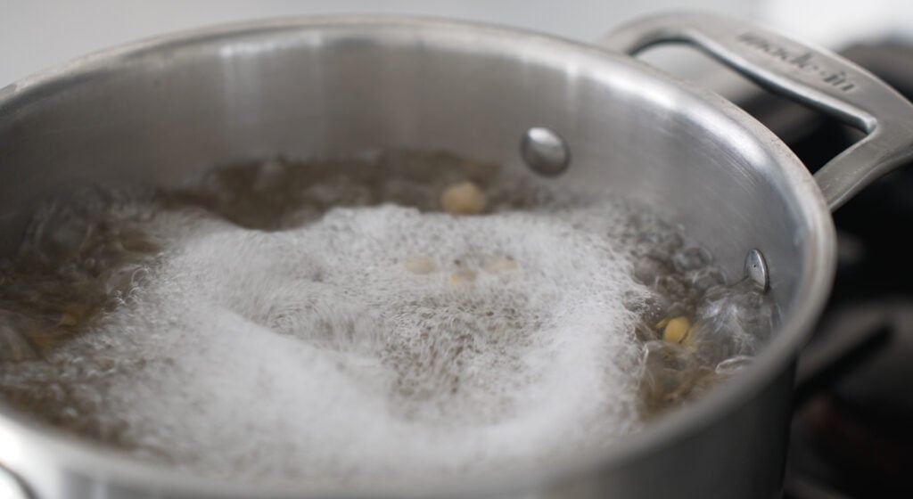 Bubbling pot of water with chickpeas