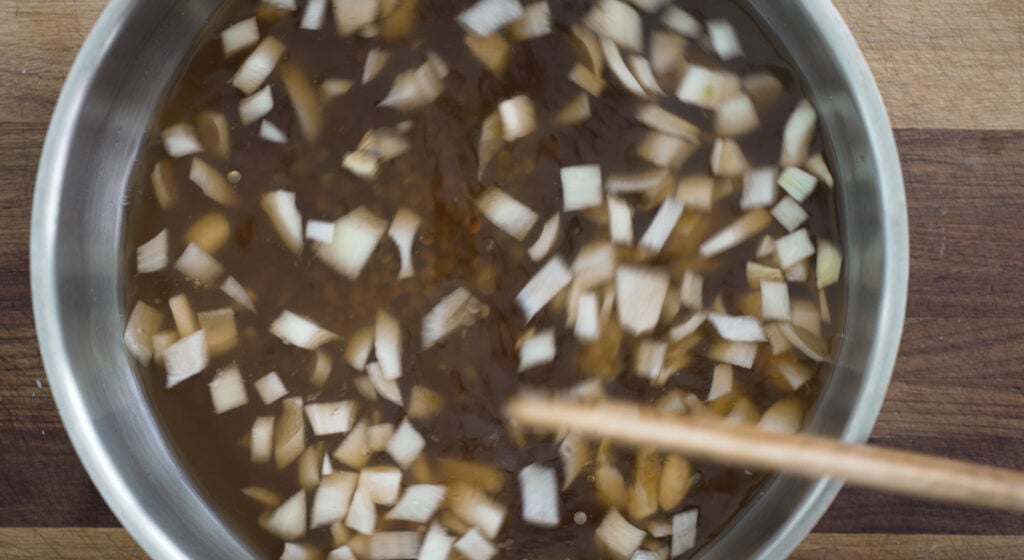 all ingredients being stirred in a pot