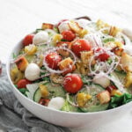 Mixed greens salad in a white serving bowl