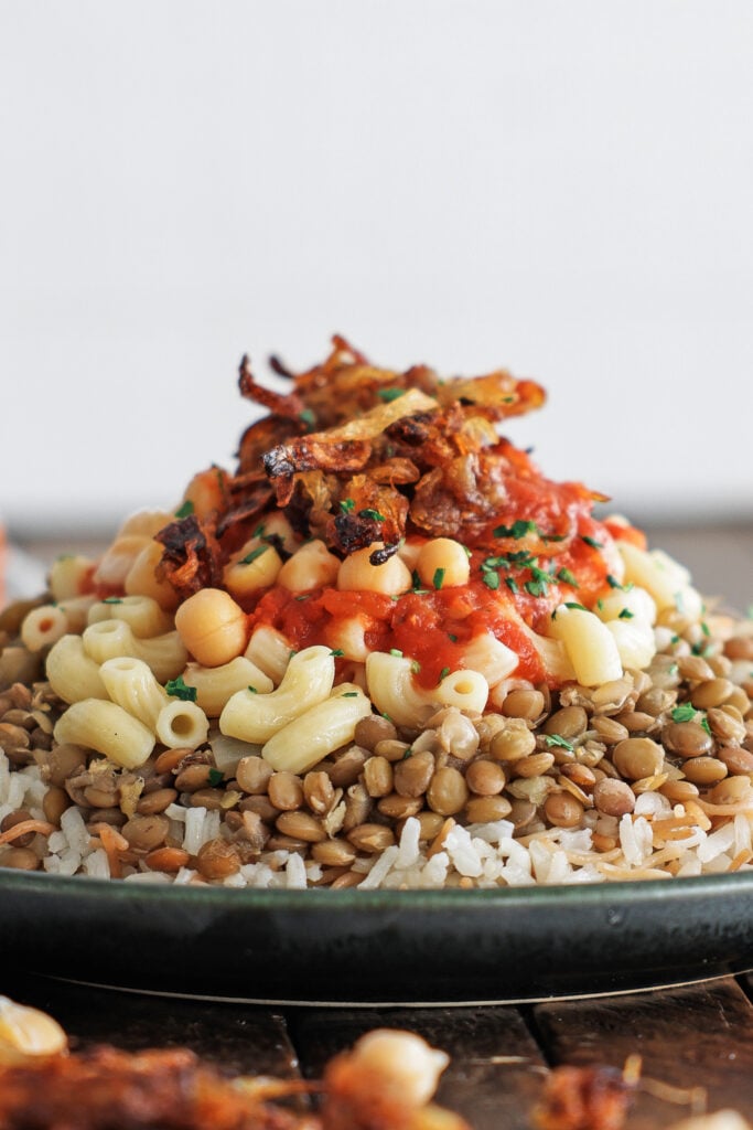 Side view of koshari on a plate