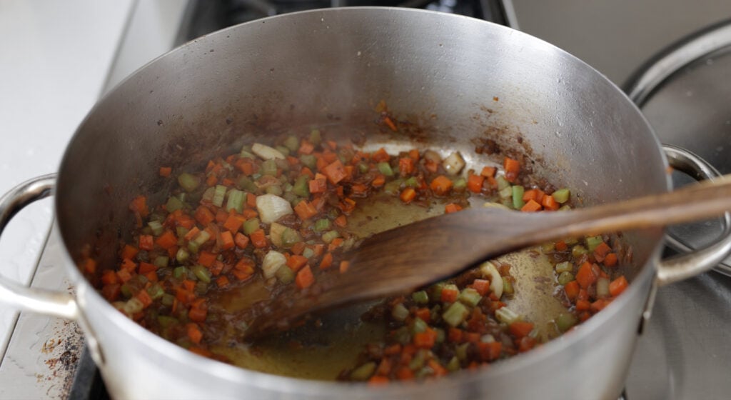 carrots, cellery and garlic added to the pot with onions