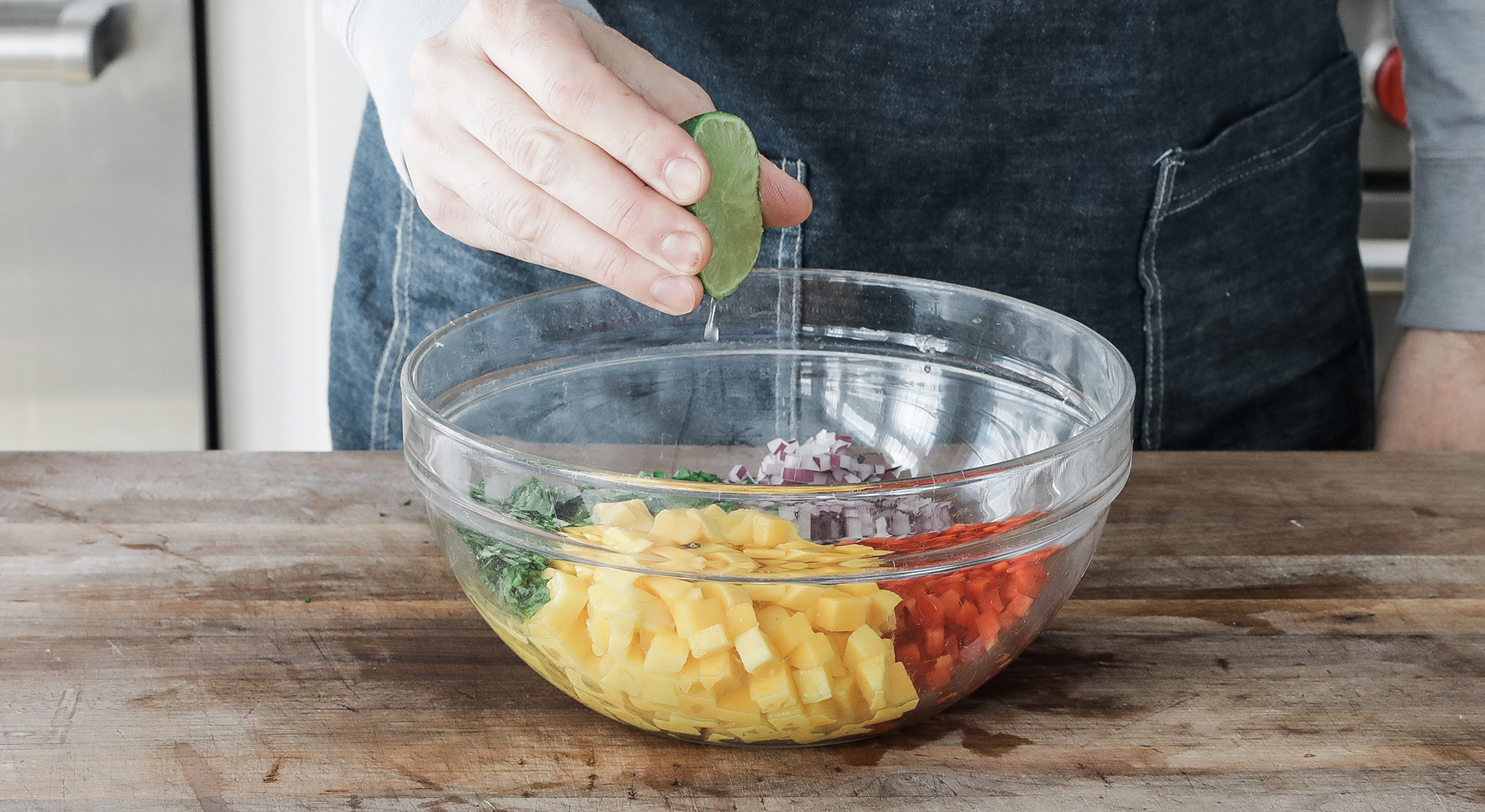 squeezing a lime into a bowl