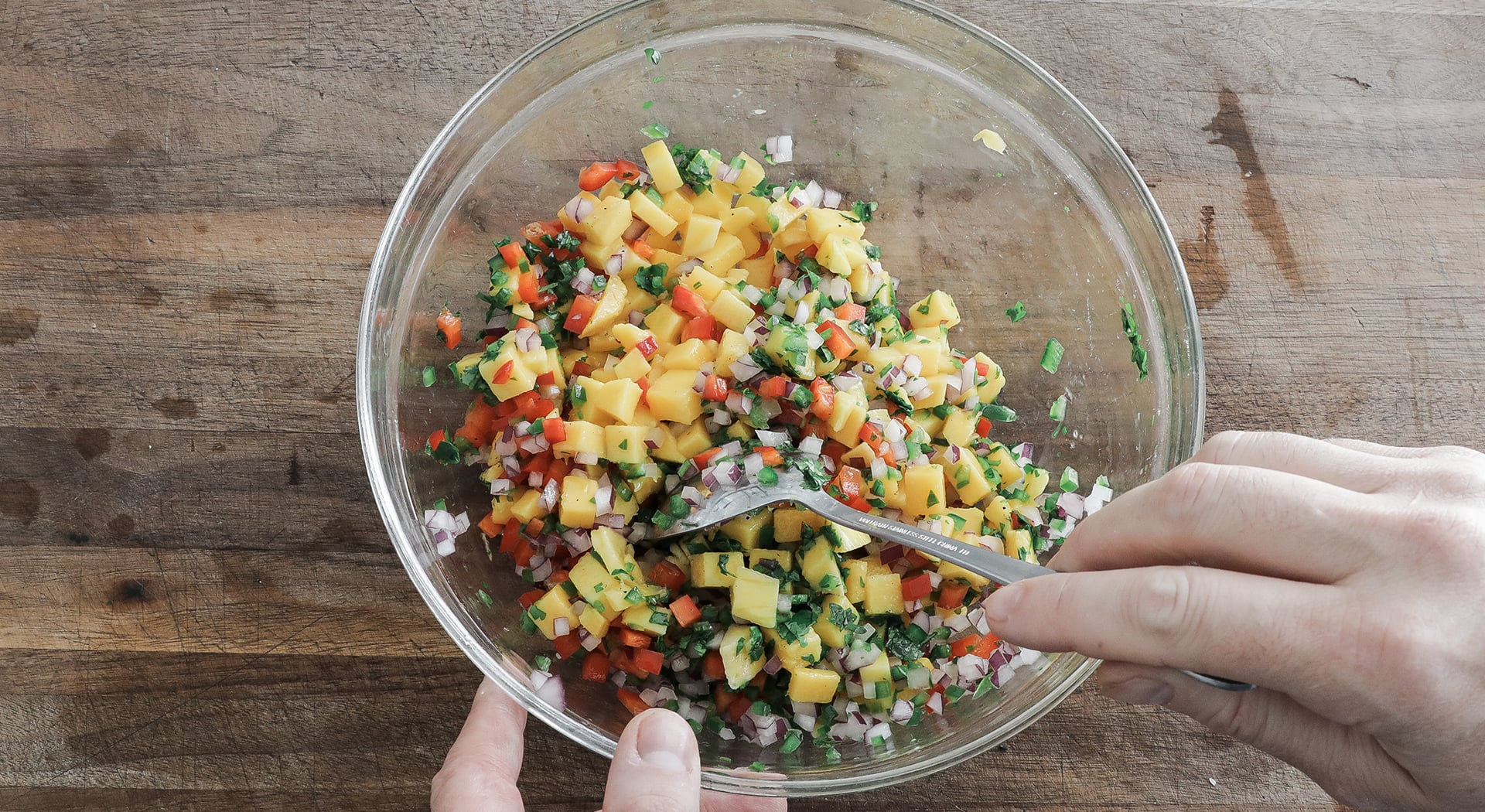 mixing a mango salsa