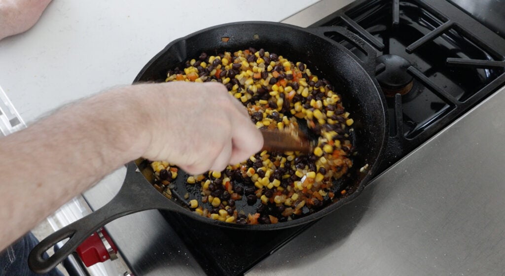 Corn and beans added into the skillet