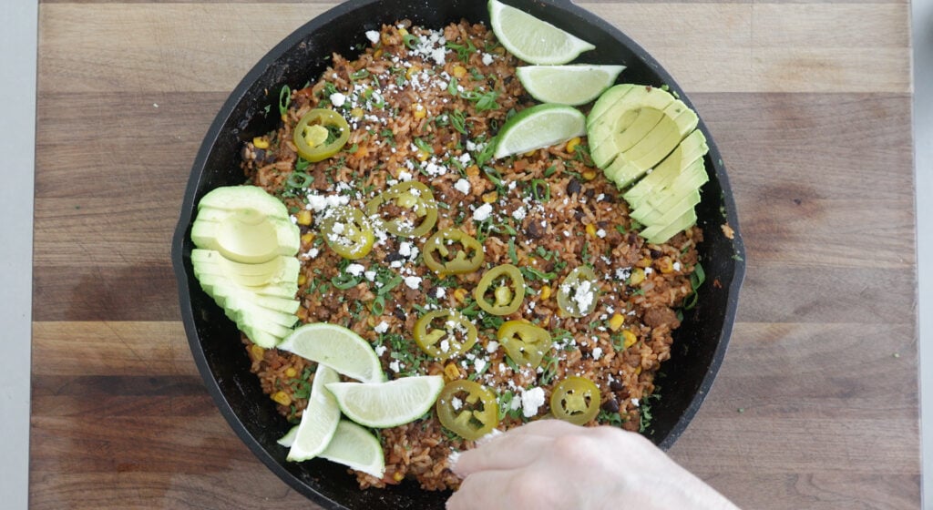 Slices of jalapeño, lime and avocado on top of the finished rice