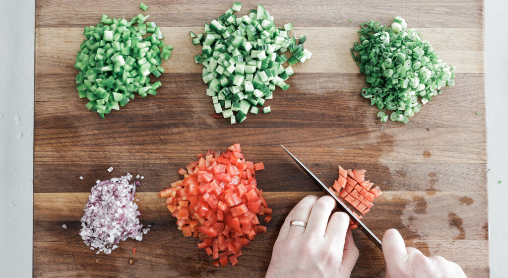 chopped ingredients for salad on a cutting board