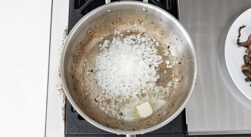 diced onions and a pat of butter in a pan