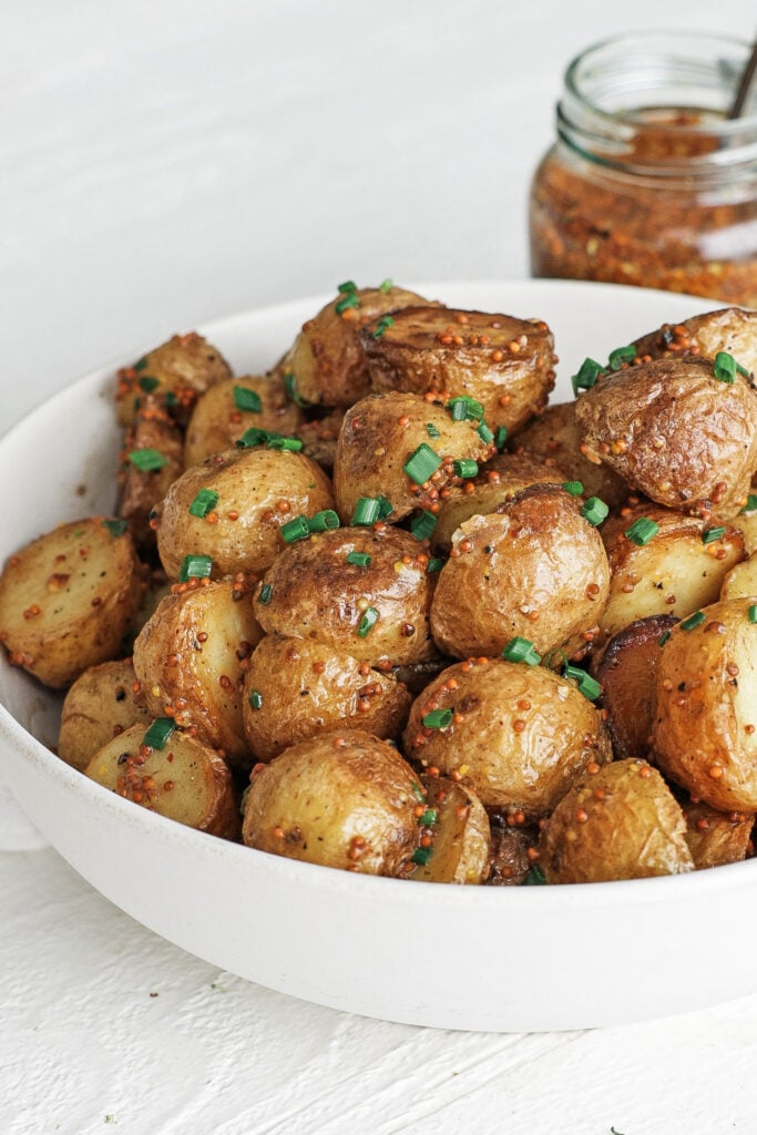 Mustard potatoes in a white serving bowl