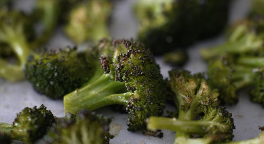a close up of a piece of browned broccoli