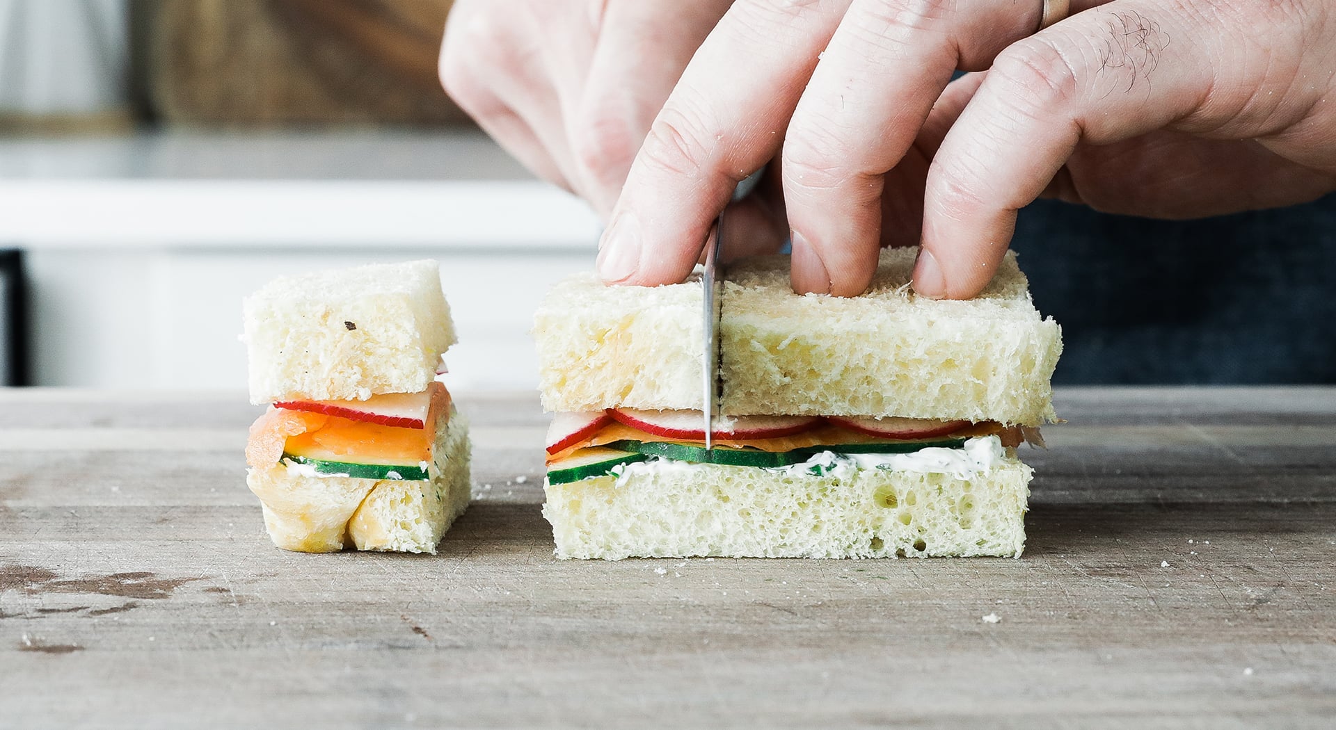 slicing a tea sandwich