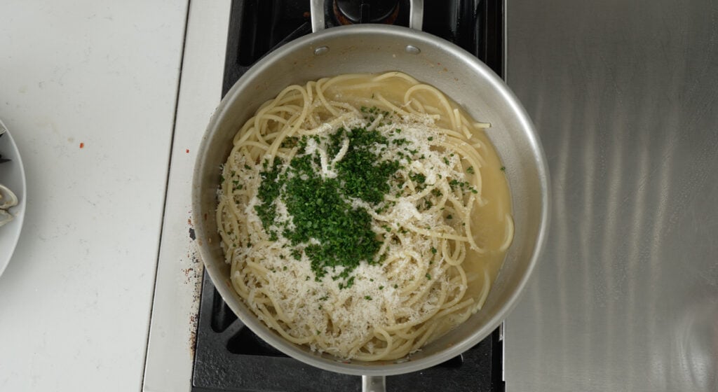 pasta in pan with cheese and parsley on top
