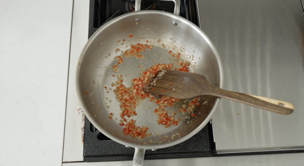 Garlic, shallots and red peppers in the pot