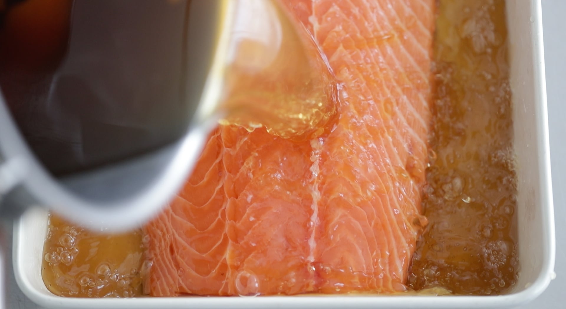 pouring a brine onto salmon