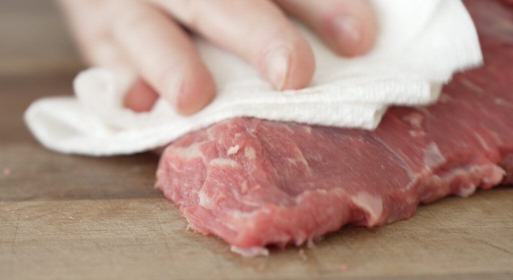 patting tri tip dry