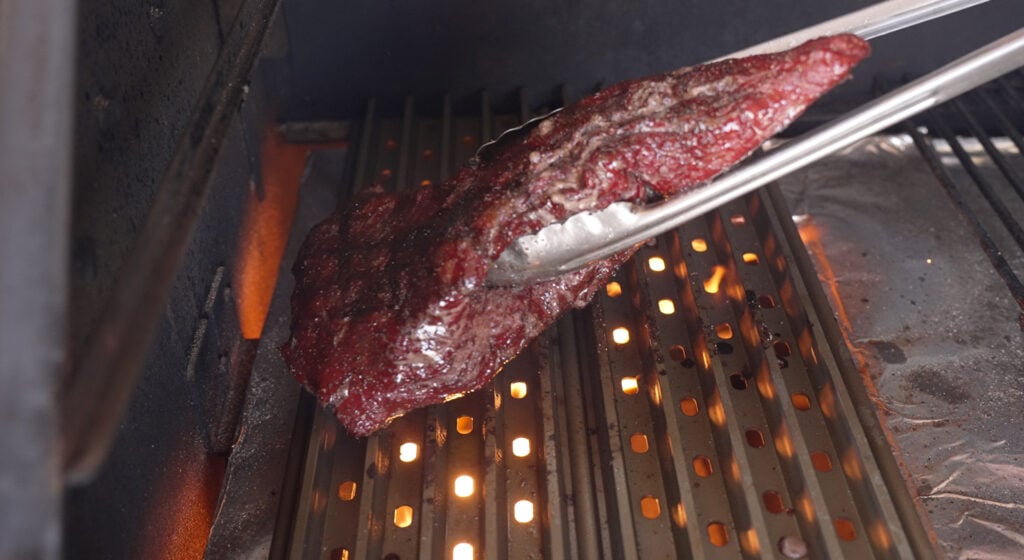 using tongs to hold the tri tip
