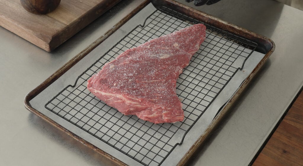 tri tip on a rack over a sheet tray
