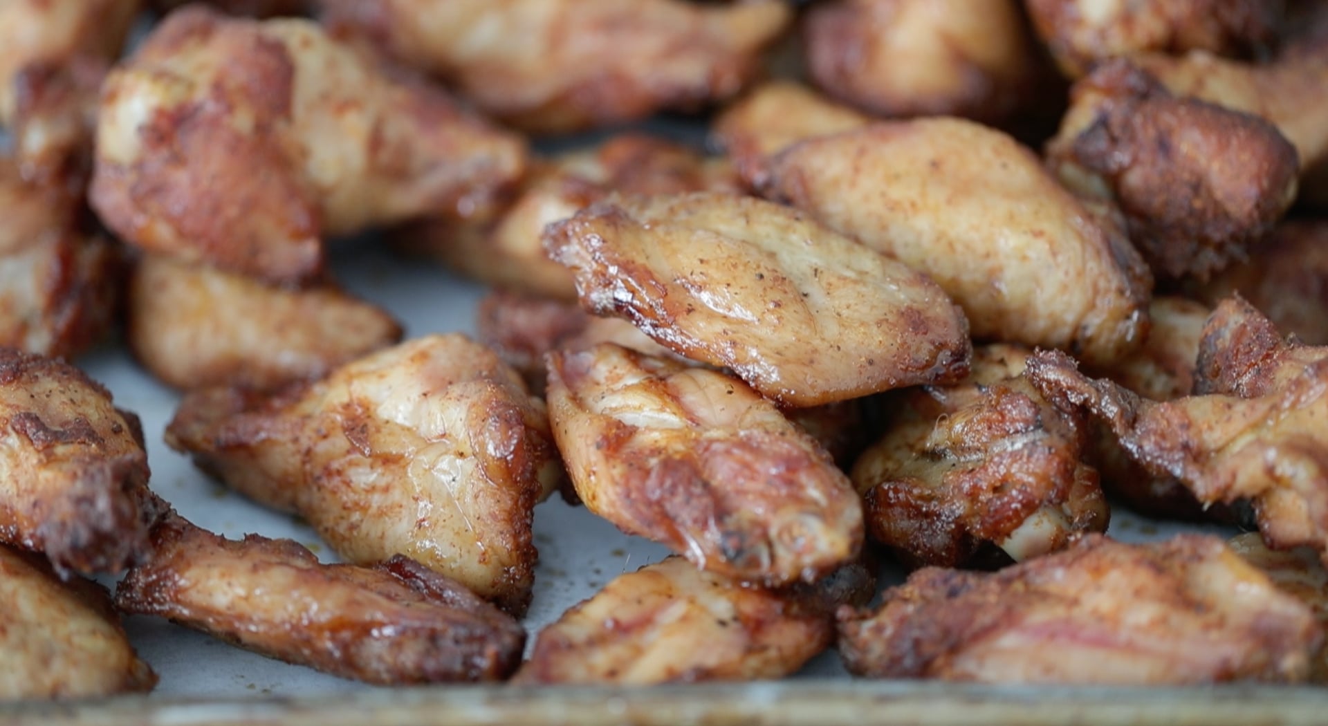 adding smoked wings to a sheet tray