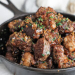 Cooked Steak bites in a cast iron pan