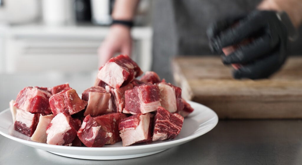 Cubes of steak piled on a plate