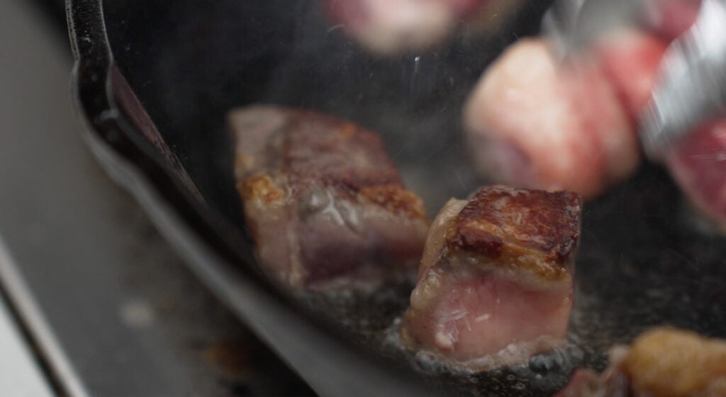 Close up of steak bites in a cast iron skillet