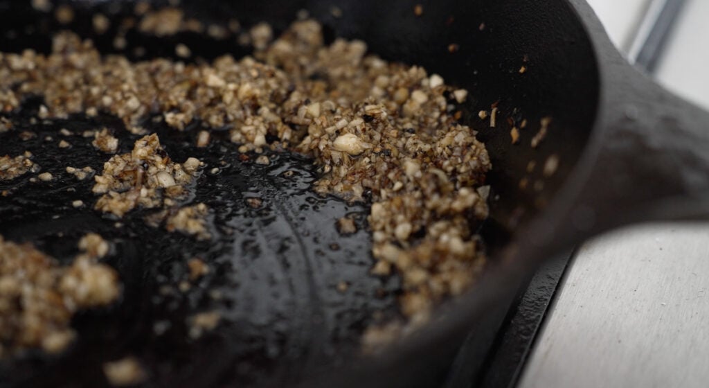 Cast iron pan with browned garlic and shallots
