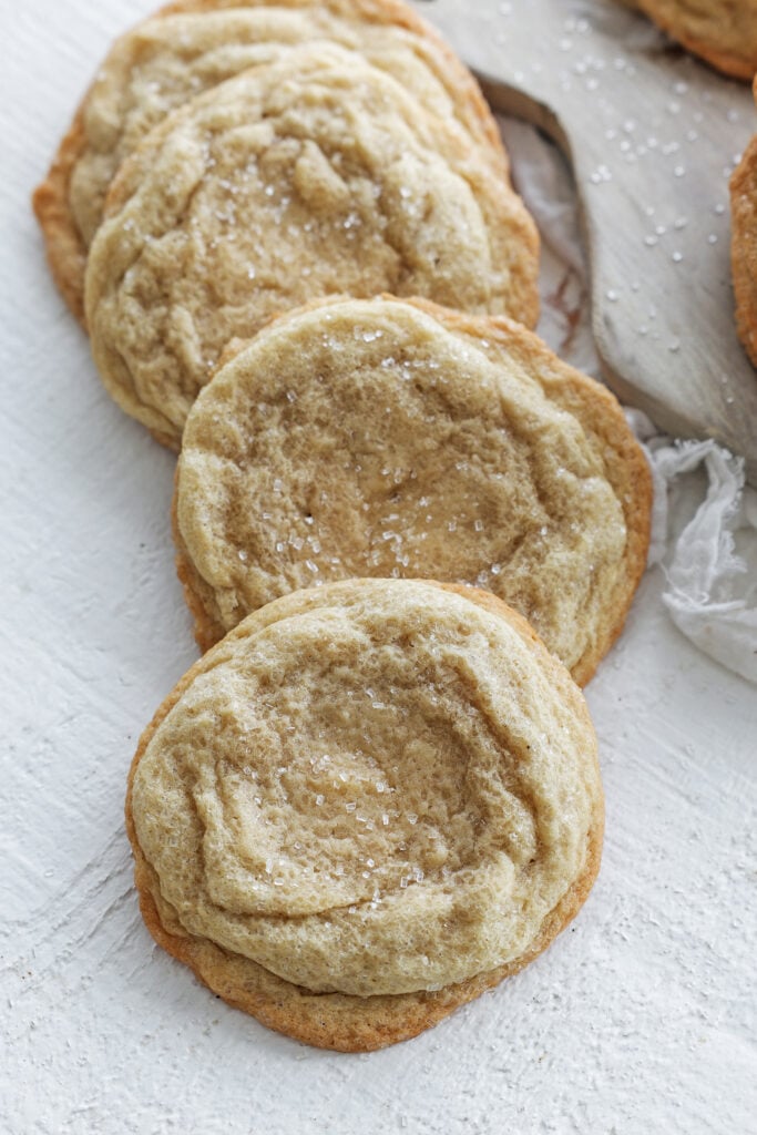 Sugar cookies laying on a table overlapping