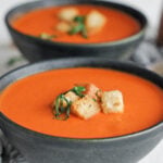 Bowl of tomato soup with croutons on top