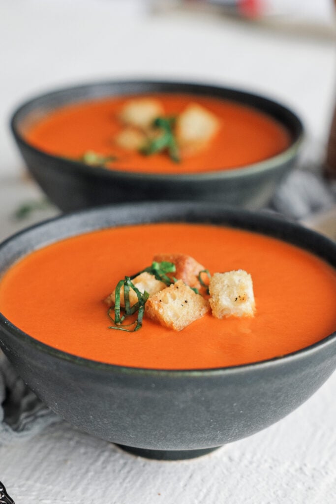 Bowl of tomato soup with croutons on top