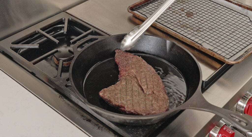 A steak placed in a large pan