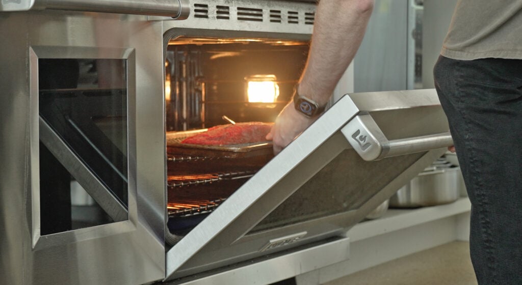Placing the steak on a pan in the oven