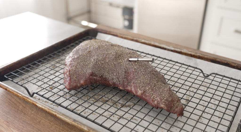 cooked Steak on a wire rack over a sheet tray