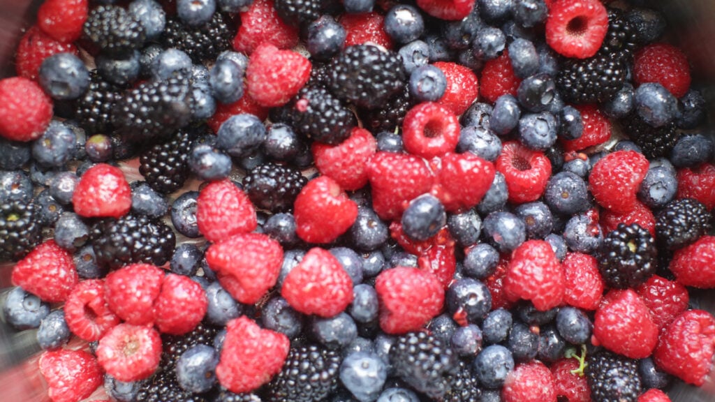 blueberries, raspberries, and blackberries in a large bowl