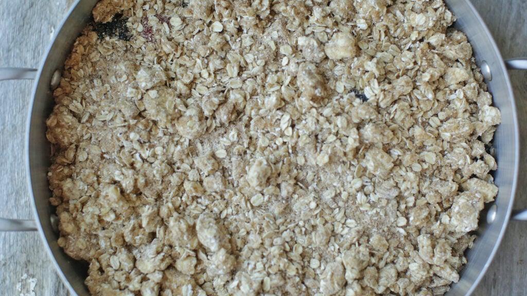 Scattering the streusel over the berries