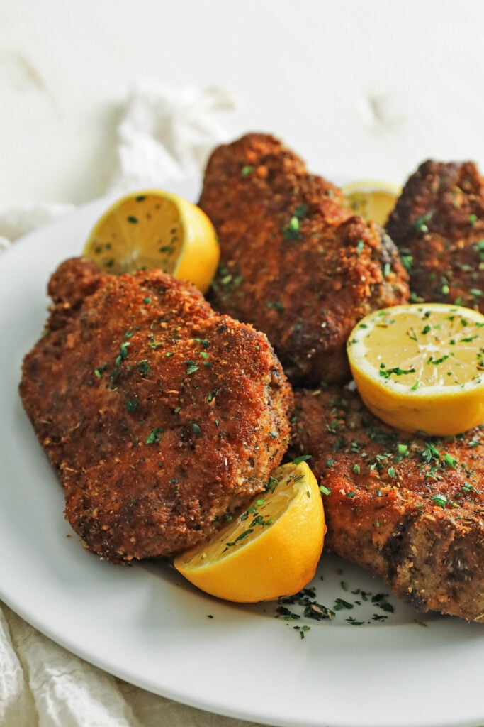 a plate full of fried pork chops with breading
