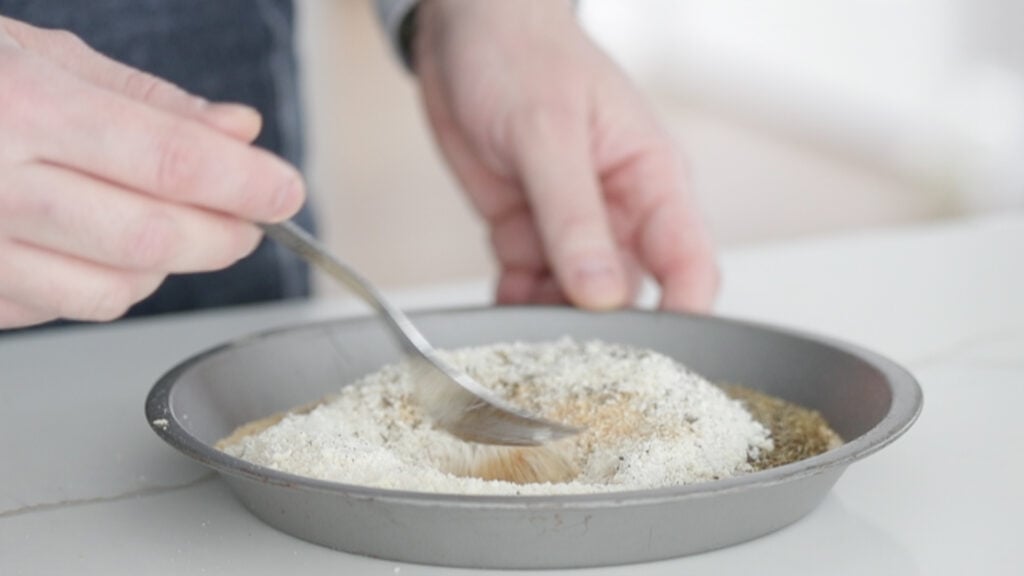 mixing bread crumbs and spices together in a pan