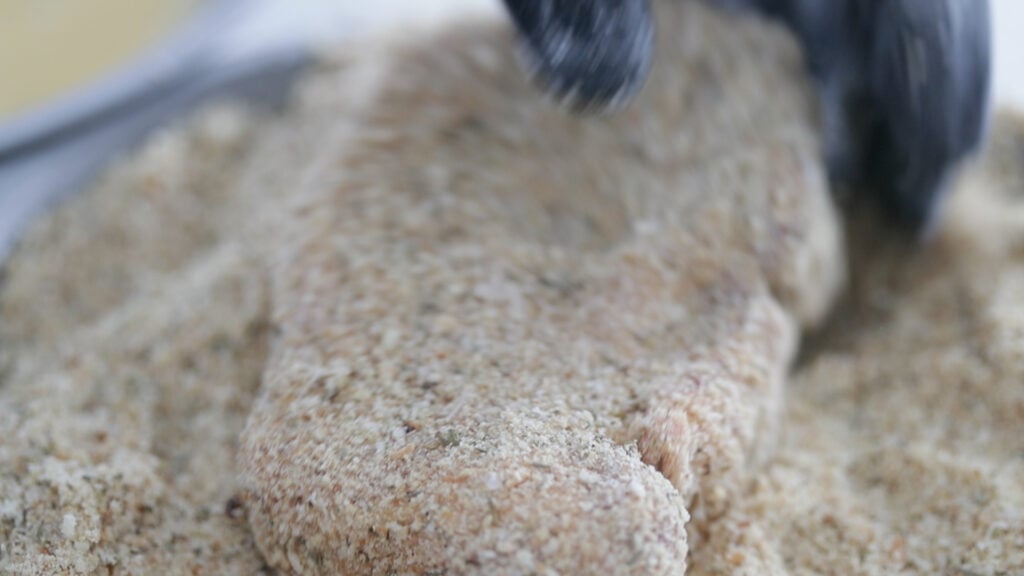coating a pork chop in bread crumbs